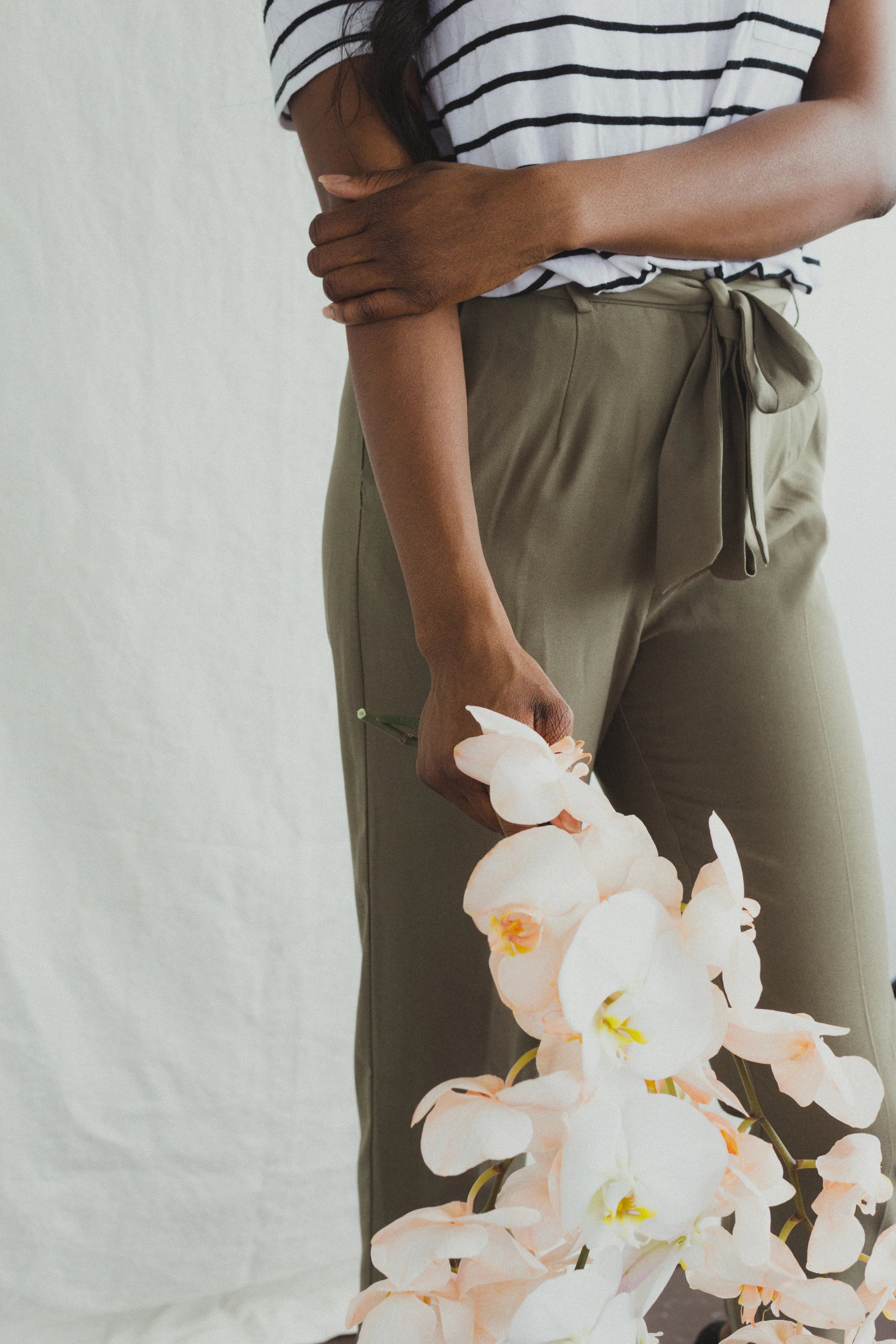files/a-model-in-khakis-holding-orchids.webp